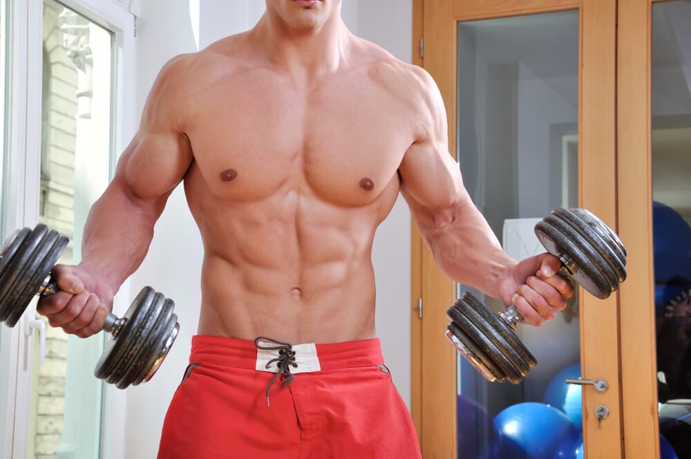 Powerful muscular man lifting weight