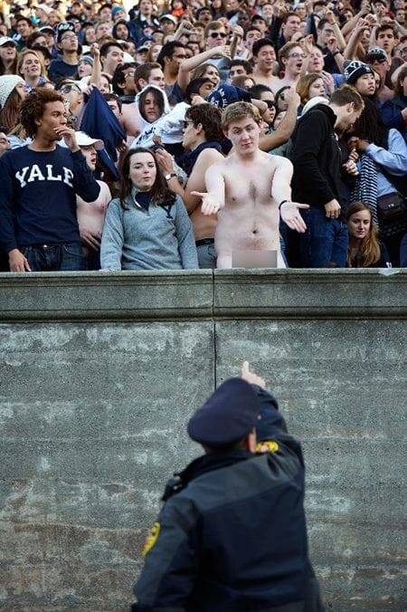 BOSTON, MA - NOVEMBER 19: (EDITORS NOTE: Image contains nudity.) A naked fan talks with a policeman during the game between the Yale Bulldogs and the Harvard Crimson at Harvard Stadium on November 19, 2016 in Boston, Massachusetts.   Adam Glanzman/Getty Images/AFP